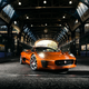 A Jaguar C-X75 concept car in orange in a tunnel in London